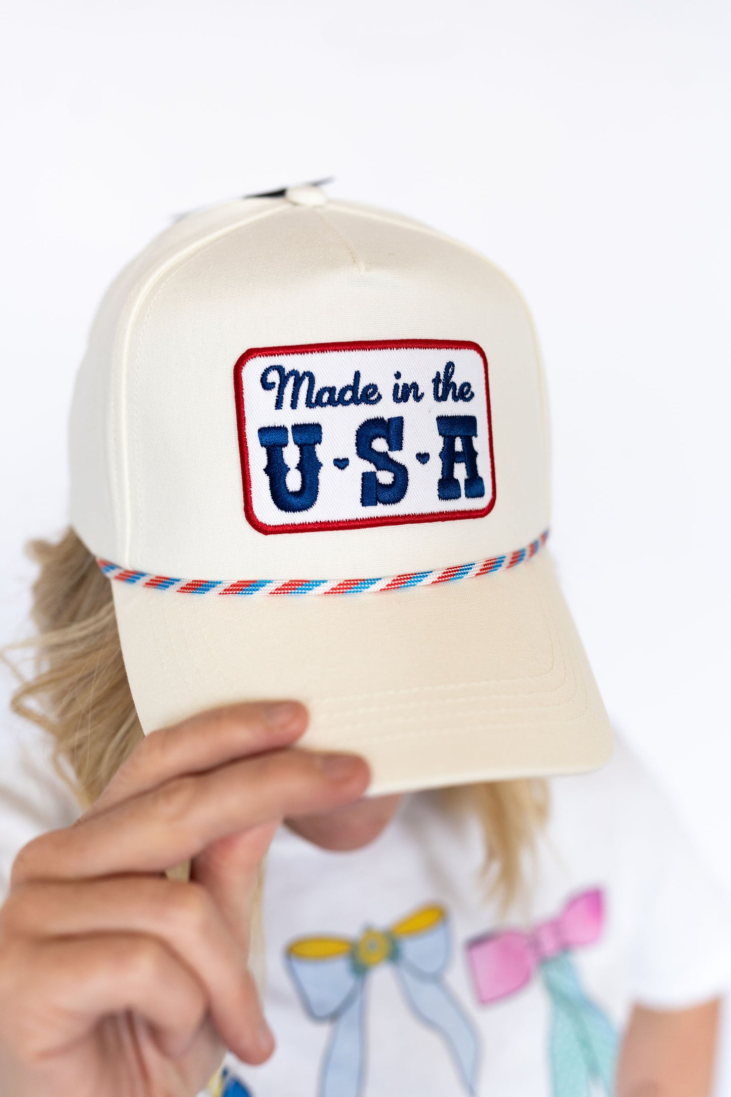 Made in the USA hat, Cream structured trucker style,
Embroidered patch with vintage flair, Colorful rope trim ,
Snapback closure for a comfy, custom fit