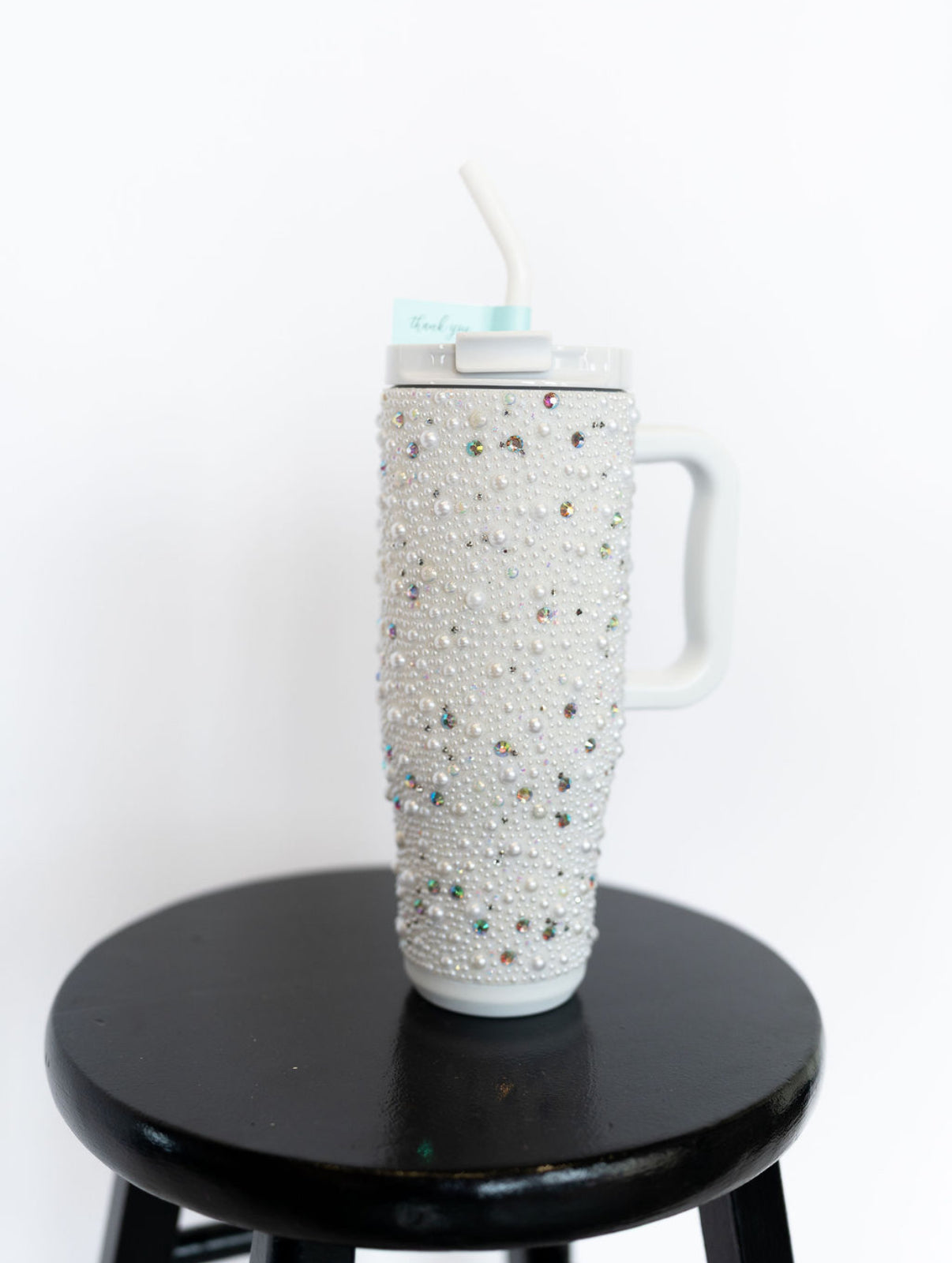 Fully embellished with pearls and rhinestones
Handle for easy carrying
Flip-top lid with reusable straw
Double-wall insulation keeps drinks hot or cold for hours
40 oz capacity
Fits most car cup holders