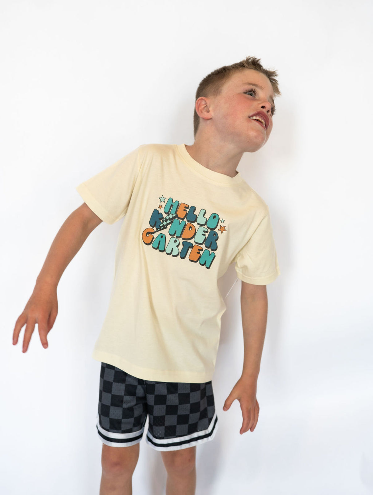 Details:
Soft, lightweight cotton blend for maximum comfort
Cream base with multicolor “HELLO KINDERGARTEN” graphic
Unisex fit—easy to pair with shorts, jeans, or joggers
Ideal for first-day-of-school outfits and milestone memories
Available in youth sizes