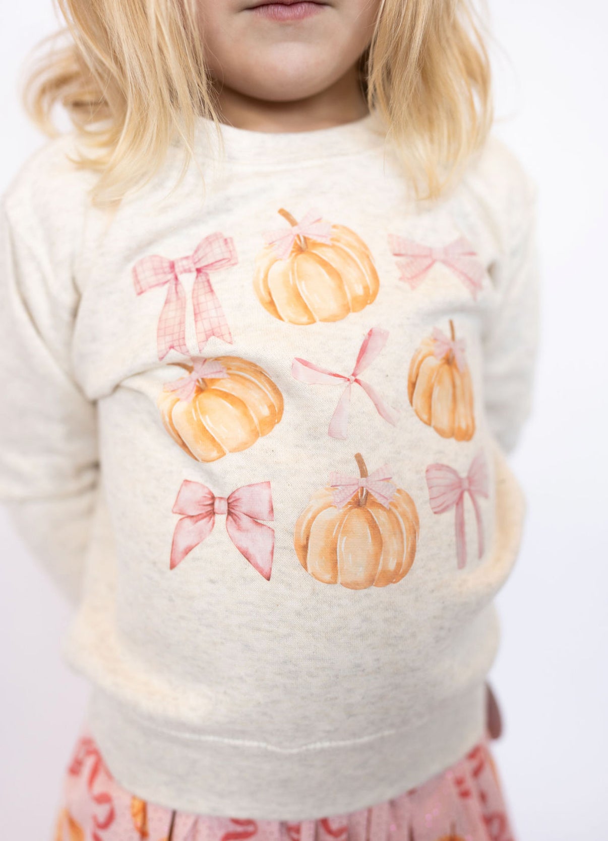 Ivory crewneck with pumpkin + pink bow print
Cozy, soft fabric perfect for cooler days
Classic crewneck fit for easy layering
Designed by Sweet Wink for playful seasonal style