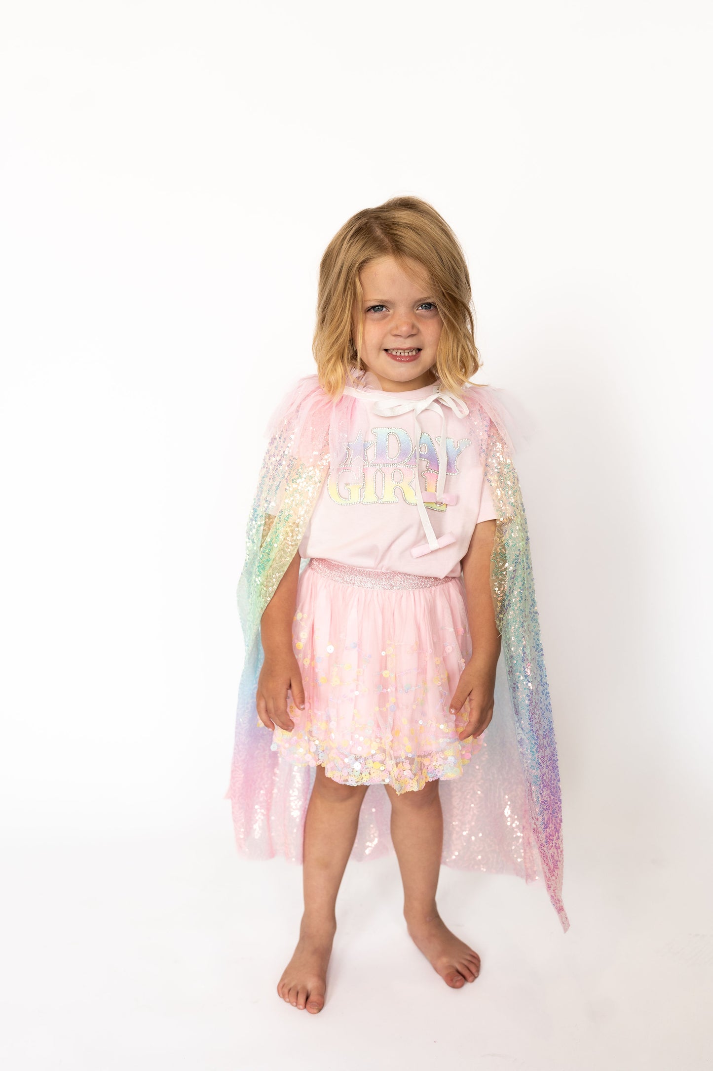 Confetti cape, Iridescent rainbow sequins for major sparkle, Soft tulle overlay thatโs comfy and non-scratchy, Ruffle neckline with satin ribbon tie,One size fits most toddlers + little kids