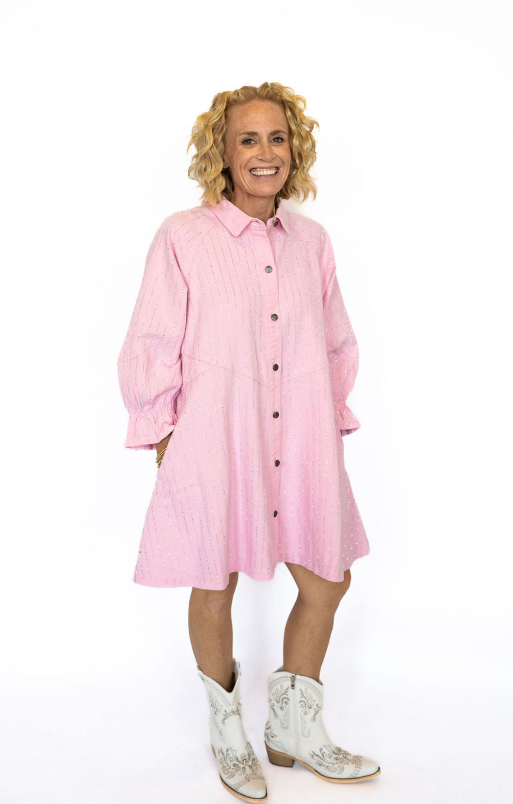 Turn heads with the sweetest sparkle in our Pink Veveret Rhinestone Denim Dress! This playful button-down style combines a soft blush denim with all-over rhinestone stripes for the perfect mix of feminine charm and everyday comfort.
✨ Details:
Light pink denim with shimmering vertical rhinestone accents
Button-down front for easy wear
Relaxed, slightly oversized fit for a flattering drape
Side pockets for function and style
3/4 length sleeves with ruffled elastic cuffs
Available in sizes S–L