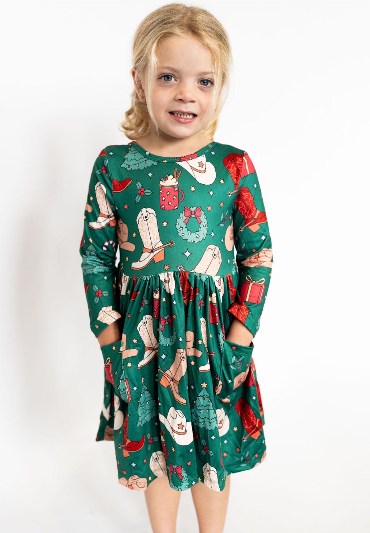 Sizes: 2T–7/8
Long sleeves for cozy comfort
Soft, stretchy fabric for all-day play
Full skirt with twirl factor
Hidden side pockets
Festive western print featuring boots, hats, wreaths & gifts