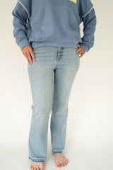 1822 Denim Women's light wash high-rise straight leg jeans with subtle fading, classic five-pocket styling, and full-length relaxed fit on a white background.
