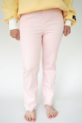 "1822 Denim Women's blush pink high-rise straight-leg jeans with raw frayed hem and stretch denim on a white background."