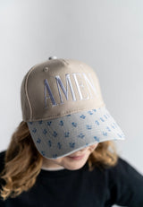 AMEN embroidered women's trucker hat with blue floral brim worn by teen, tan faith baseball cap boutique style