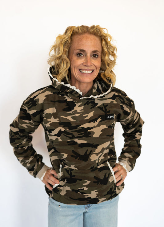 Signature Ampersand Ave triple stretch fabric for comfort &amp; flexibility

All-over camo print with contrasting white lace hood detail

Front kangaroo pocket for style and function

Ribbed cuffs &amp; hem for a cozy fit

Available in Women’s sizes S–XL