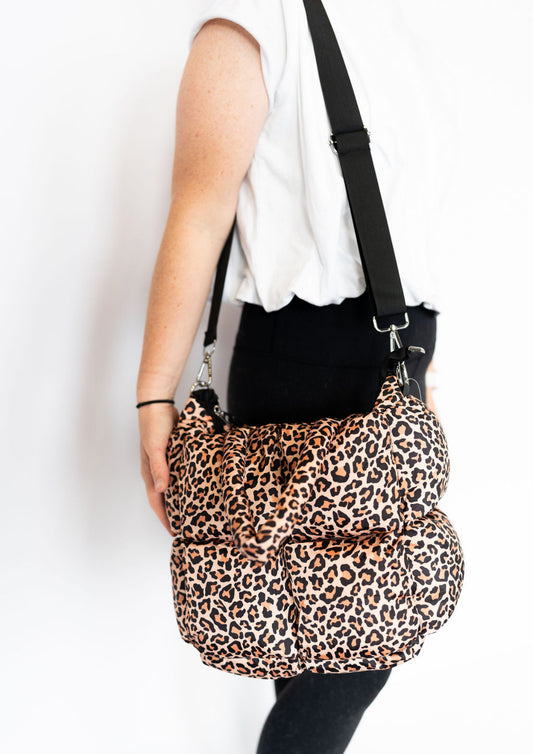 14” x 12” x 7.5”
100% polyester
Puffy quilted material
Zipper closure
Magnetic clasp for extra security
Interior zipper pocket for small essentials
17” handle straps for easy carry
Detachable, adjustable over-the-shoulder strap (extends to 47”)