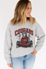 Heather gray Cougars crewneck sweatshirt featuring a vintage cougar mascot and stadium graphic with red rhinestone embellishments.