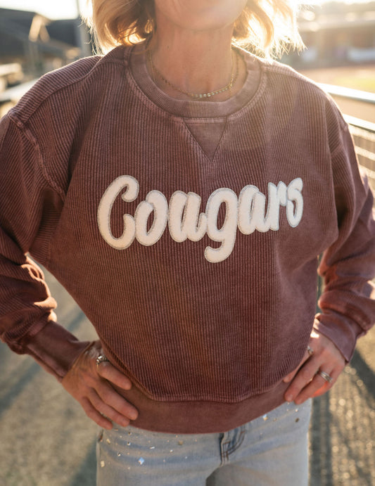 Details:

Soft, mineral-washed maroon corded fabric

Bold white chenille "Cougars" lettering

Relaxed, easygoing oversized fit

Durable ribbed neckline, cuffs, and hem

Available in women's sizes S-XL