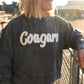 Details:

Soft, mineral-washed navy corded fabric

White chenille "Cougars" lettering

Comfy, relaxed oversized fit

Ribbed neckline, cuffs, and hem for durability

Available in sizes S-XL
