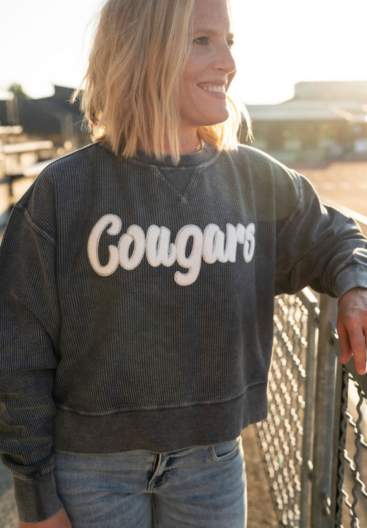 Details:

Soft, mineral-washed navy corded fabric

White chenille "Cougars" lettering

Comfy, relaxed oversized fit

Ribbed neckline, cuffs, and hem for durability

Available in sizes S-XL