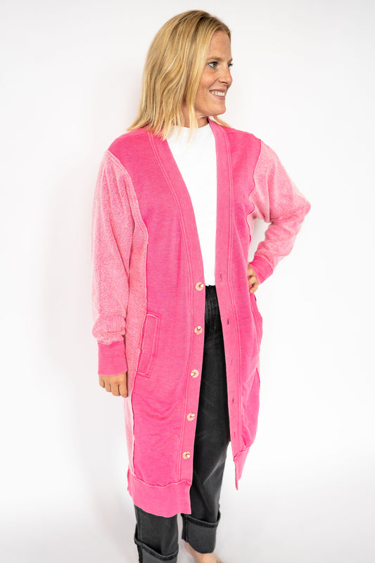 Vibrant pink body with textured contrasting sleeves

Longline fit with front button closure

Functional front pockets for all the essentials

Soft + comfy sweatshirt material for everyday wear

Relaxed fit – easy to style up or down

Available in XS or One Size