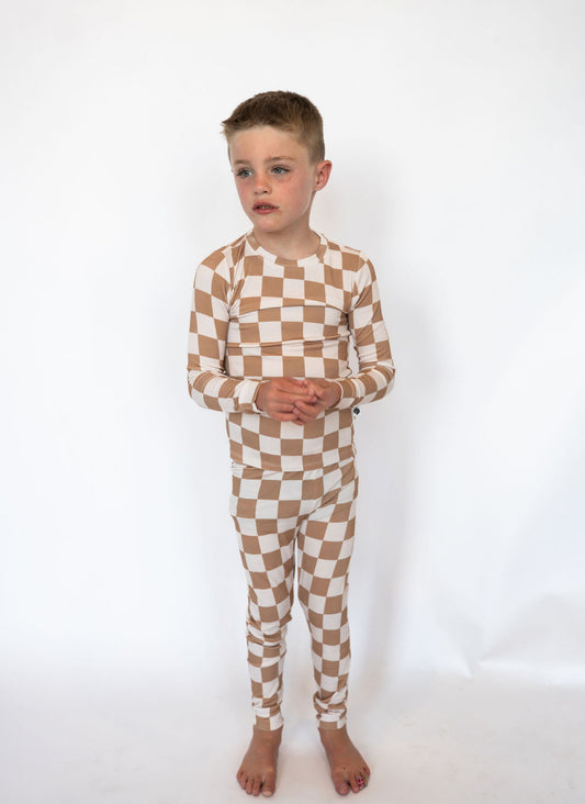 Made from ultra-soft, breathable bamboo viscose that keeps them comfy all night

Ribbed texture for extra stretch and easy movement

Stylish tan-and-ivory checkered “Dunes” print

Two-piece set with a long-sleeve top &amp; matching pants

Naturally hypoallergenic and gentle on sensitive skin
