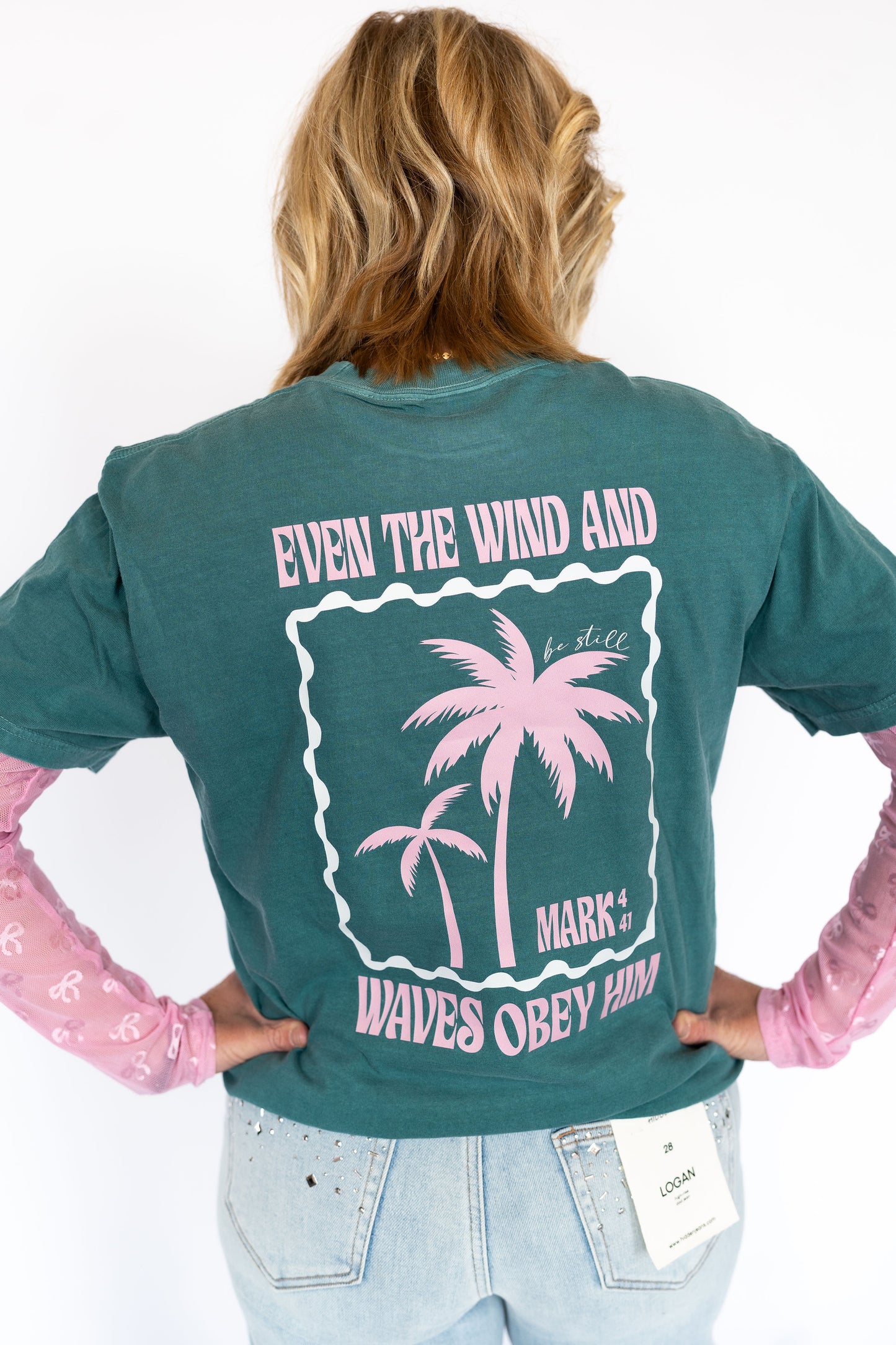 Even the Wind and Waves Obey Him tee, Comfort colors-style deep teal tee, Pink palm tree print on front and back, Inspiring Scripture: Mark 4:41, Relaxed fit, perfect for layering, Faith-forward and effortlessly cool
