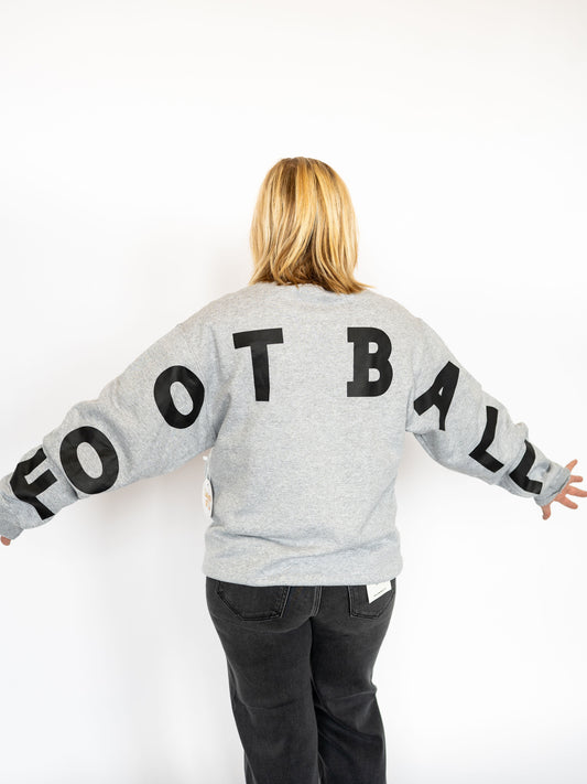 Classic grey with bold GAME DAY print on the front
Oversized FOOTBALL lettering across the back + sleeves
Soft, midweight fabric perfect for layering on chilly nights
Relaxed unisex fit – great for pairing with jeans or leggings
Sizes: S–XL