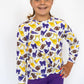 Details:

All-over purple, gold, and white game day graphic print

Soft, stretchy athletic fabric for comfort and movement

Long sleeves with a lightweight, breathable feel

Stylish criss cross hem detail for a flattering fit

Perfect for game days, pep rallies, or everyday spirited wear

