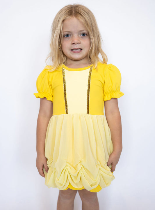 Soft puff sleeves with ruffle trim for a classic princess look
Golden bodice with sparkling trim accents
Gathered, ruched skirt for an elegant ballgown feel
Sweet bow-back cutout detail for extra charm
Built-in matching shorts for all-day comfort and play
Lightweight, stretchy fabric that moves with your little one