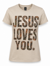 Women's tan short sleeve graphic t-shirt featuring large camo-print "Jesus Loves You" lettering accented with rhinestone details on a white background.
