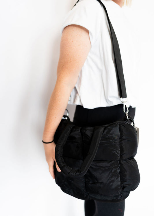 Quilted puffer material
Zipper closure for security
Soft, padded handles for easy carry
Detachable & adjustable shoulder strap (extends to 47”)
Interior zipper pocket for small essentials
Lightweight, slouchy-chic design
Approx. 14” x 12” x 7.5”