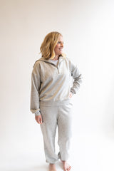 Woman wearing a gray quarter zip and joggers on a white background. Scuba Set, Athleisure, Katydid, Lounge, Comfy