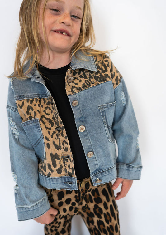 Light wash denim with distressed details for a cool, lived-in vibe

Leopard print patchwork on the front, back, and shoulders

Functional front pockets &amp; button-up closure

Slightly relaxed fit for layering over tees or sweaters

Durable cotton blend for comfort and long-lasting wear

Available in kids sizes 3–8