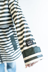 Black and White striped Drby raincoat buy Lulu Mac. Sleeve with embroidered patch on the sleeve