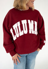 Women's Lulu Mac Stitch Sweatshirt in cardinal red with oversized white stitched LULU MAC lettering across the chest, relaxed fit, and ribbed cuffs, styled with light-wash jeans.