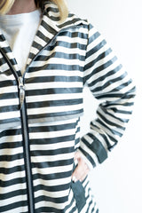 Close up of a women wearing a black and white striped Lulu Mac Darby Rain Coat