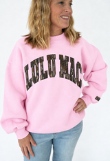 Lulu Mac light pink oversized crewneck sweatshirt featuring bold Mossy Oak Bottomland camo lettering across the chest.