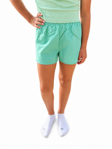 Youth mint green athletic shorts with elastic waistband, lightweight performance fabric, and relaxed fit for everyday play and active wear.