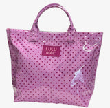 Pink Lulu Mac tote bag featuring a glossy finish, pink polka dot pattern, matching logo patch, durable shoulder handles, and a spacious carry-all design.
