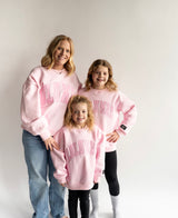 Mom and daughters wearing matching Lulu Mac Mono Light Pink crewneck sweatshirts