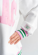 Lulu Mac sleeve detail with pink and green striped cuff and Lulu Mac logo tag