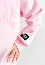 Lulu Mac logo tag on sleeve of mono light pink crewneck 