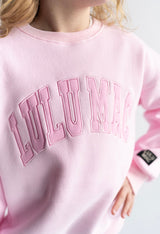 Girls Lulu Mac Youth Mono Light Pink crewneck sweatshirt close up on the text Lulu Mac across the chest