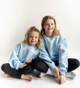 girls wearing matching Lulu Mac Mono Crew in light blue sweatshirts