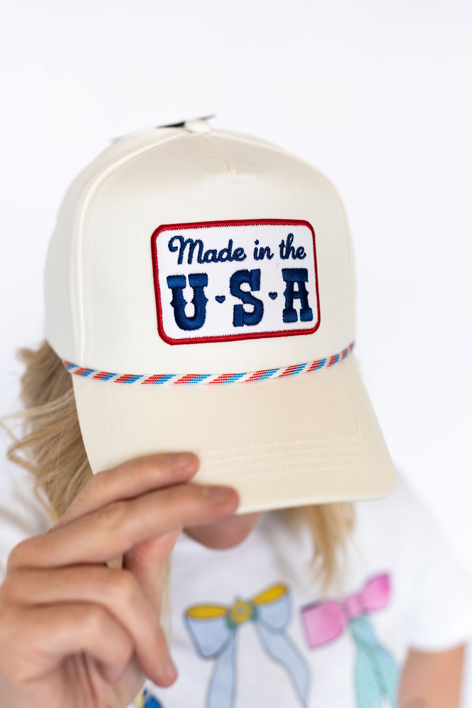 Made in the USA hat, Cream structured trucker style,
Embroidered patch with vintage flair, Colorful rope trim ,
Snapback closure for a comfy, custom fit
