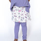 Playtime just got a major style upgrade! Our Skirted Legging is where cozy meets cute — featuring full-length lilac leggings attached to a twirl-worthy skirt decked out in the ultimate girly print. Think bows, sunnies, lipsticks, flowers, and all things fabulous in soft pastel tones. Soft and stretchy full-length lilac leggings

Attached printed skirt with pastel glam icons

Wide elastic waistband for comfy, pull-on wear

Exclusive Teigan &amp; Co. custom design

Perfect for school, playdates, and everythin
