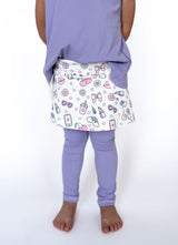 Playtime just got a major style upgrade! Our Skirted Legging is where cozy meets cute — featuring full-length lilac leggings attached to a twirl-worthy skirt decked out in the ultimate girly print. Think bows, sunnies, lipsticks, flowers, and all things fabulous in soft pastel tones. Soft and stretchy full-length lilac leggings

Attached printed skirt with pastel glam icons

Wide elastic waistband for comfy, pull-on wear

Exclusive Teigan &amp; Co. custom design

Perfect for school, playdates, and everythin