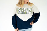 Seahawks chenille varsity colorblock sweatshirt in heather gray and navy with bold white, navy, and green SEAHAWKS lettering, relaxed fit and vintage-inspired game day style.