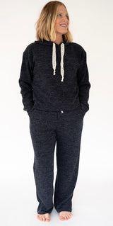 A woman modeling a Simply Southern Navy cord loungewear set, consisting of a hooded sweatshirt with cream lace drawstrings and matching sweatpants, against a plain white background.