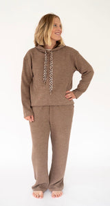 A woman modeling a matching Simply Southern tan cord lounge set consisting of a hooded sweatshirt with leopard-print drawstrings and matching wide-leg pants, photographed against a plain white studio background.