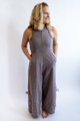 Sleeveless Washed Dark Gray wide-leg jumpsuit with a fitted bodice, racerback-style top, and relaxed flowy pants with side pockets