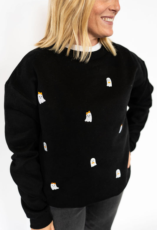 Black crewneck sweatshirt with embroidered ghost details

Soft + cozy cotton blend fabric

Relaxed, unisex fit for all-day comfort

Playful, festive design perfect for fall + Halloween

Adult sizes XS–XXL