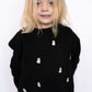 Black crewneck with allover embroidered ghost accents

Ghosts feature orange bows + bow ties for extra charm

Soft + cozy fabric for everyday wear

Unisex fit for easy styling