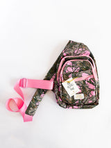 Pink and green camo print with coordinating pink zippers and strap
Adjustable crossbody strap for the perfect fit
Multiple zip compartments to keep essentials organized
Lightweight, durable canvas construction
Gold “The Sling Bag” tag with signature Simply Southern branding
Size: approx. 12" H x 7" W x 3" D