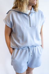 Light blue women’s matching set with short sleeve quarter zip top and drawstring shorts, casual lounge outfit