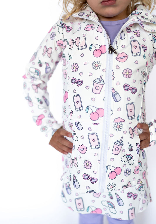 Cool days, meet your match. The Glam Girl Zip-Up Jacket is your mini fashionista’s new favorite layer! Featuring our custom Teigan & Co. glam print—loaded with hearts, bows, lip gloss, sunnies, and all the girlie essentials—this jacket brings big personality in the sweetest pastel palette.

Designed for comfort, cuteness, and confidence, this zip-up is perfect for school days, play dates, or adding extra sparkle to any outfit.

Details:

Full front zipper with easy-pull heart zipper detail
Soft and stretchy