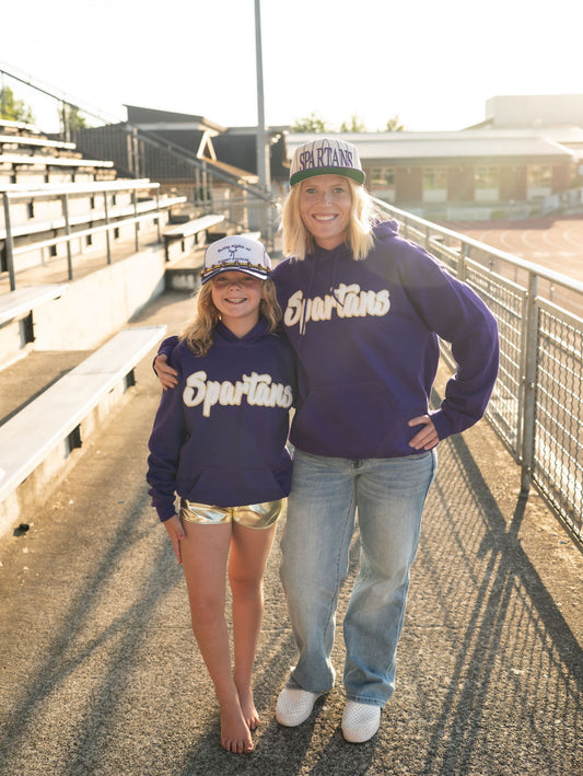 Details:

Deep purple hoodie with bold white &amp; gold “Spartans” chenille patch

Classic kangaroo pocket

Ribbed cuffs and waistband

Soft fleece-lined interior

Unisex fit – cozy and relaxed

Available in Adult sizes S–XL
